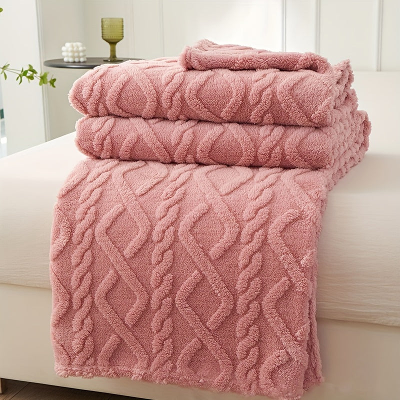 Stack of pink textured towels on a white surface