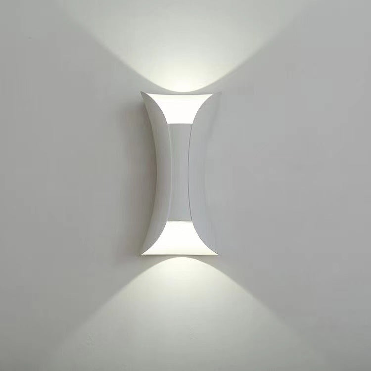 Modern wall-mounted light fixture on a white wall