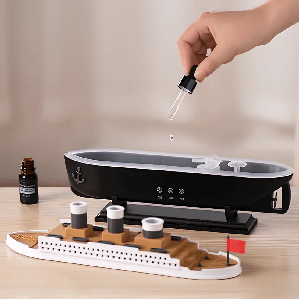 Model ship with a small device and hand dropping liquid onto it on a neutral background