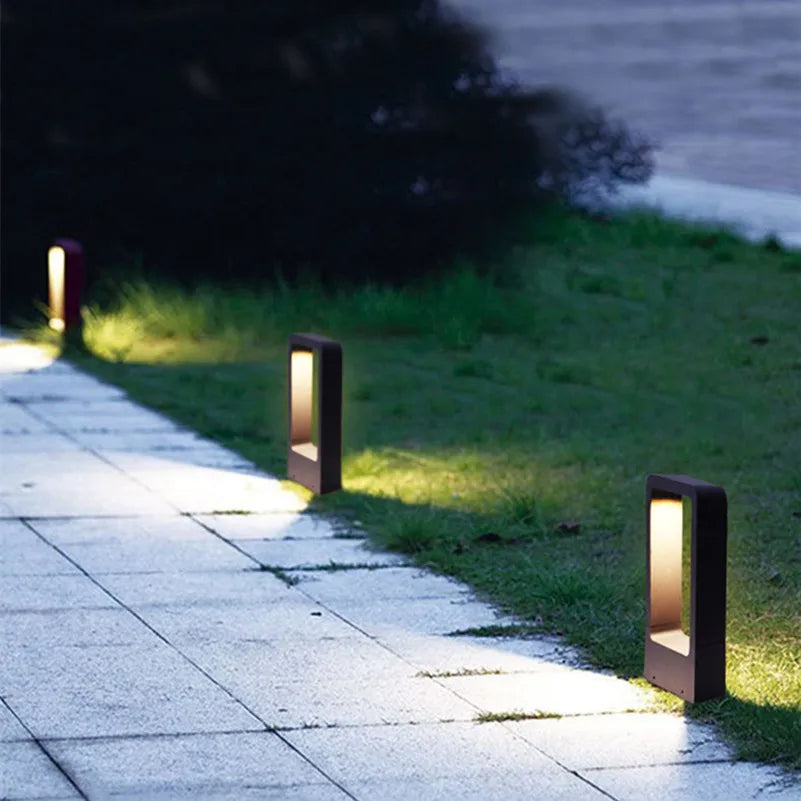 Garden pathway with outdoor lights illuminating the grass