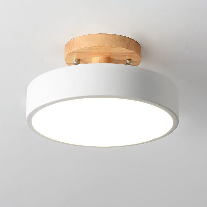 Ceiling light fixture with wooden top cover on a plain background