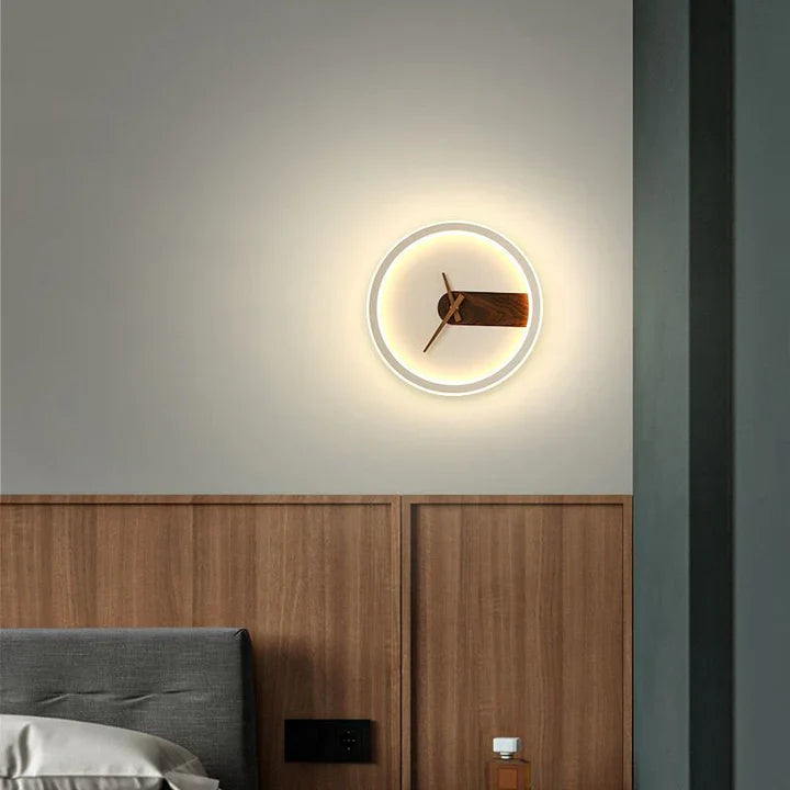 Modern wall clock with illuminated face on a bedroom wall