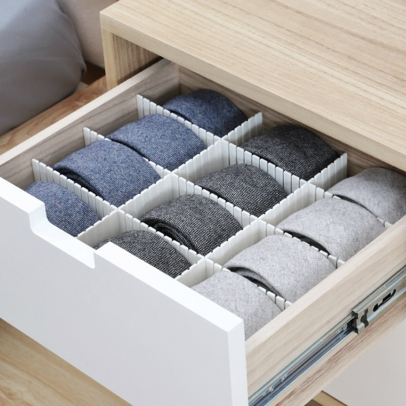 Drawer with organizer holding blue, gray, and white socks.