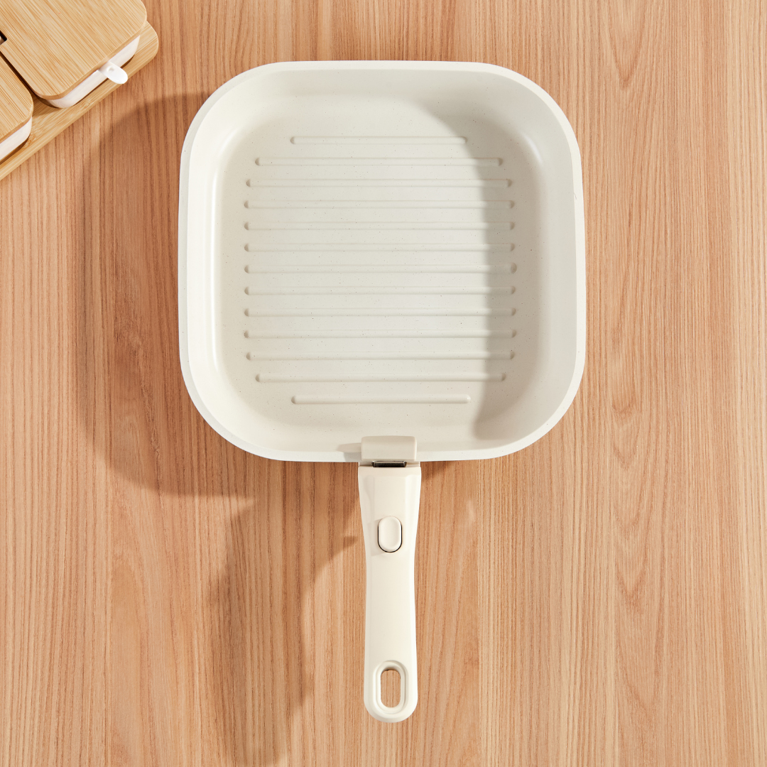 White square pan with handle on a wooden surface