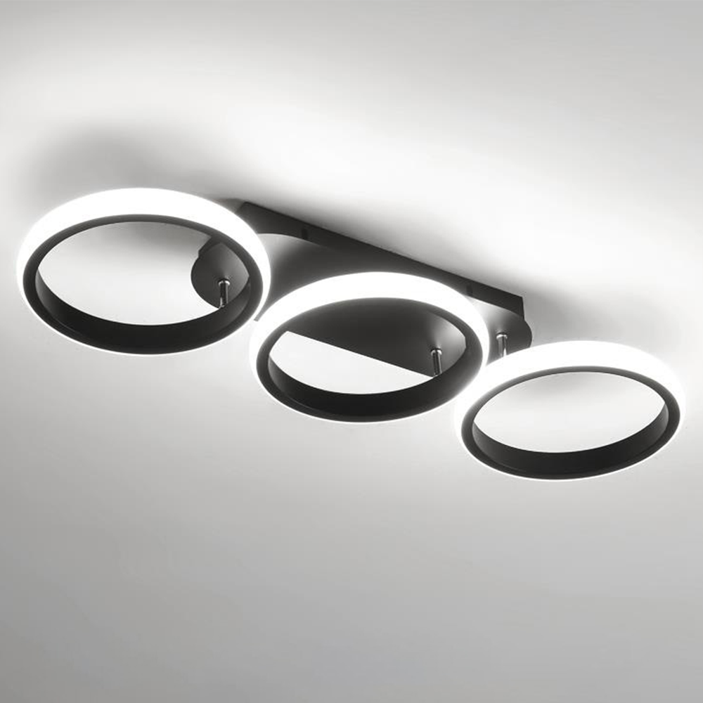 Modern ceiling light fixture with three circular rings on a gray background