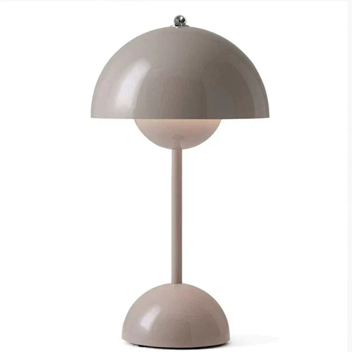 Modern table lamp with a beige shade and base on a white background