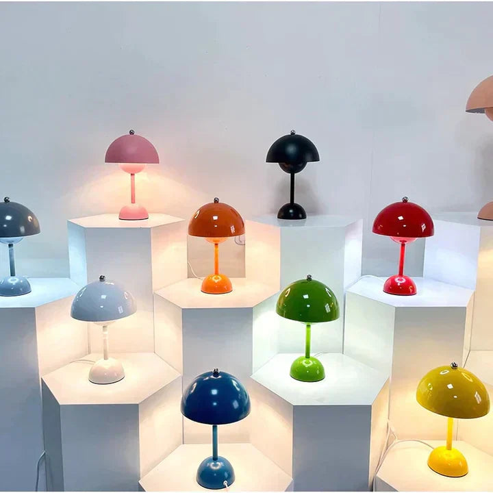 Colorful table lamps on white shelves against a light gray background