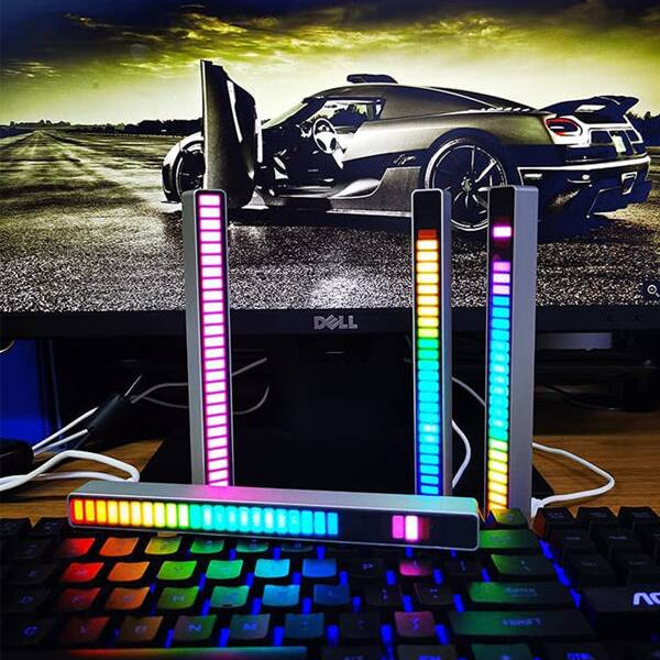 Colorful LED lights on a keyboard with a car in the background