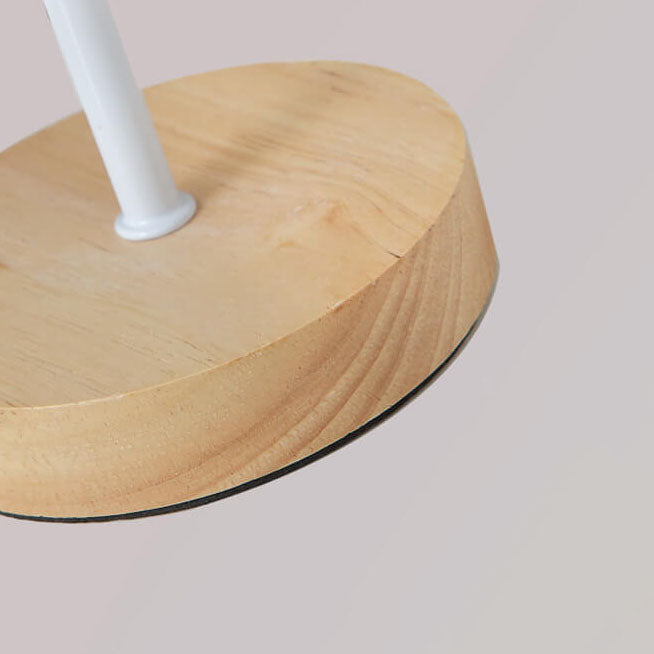 Wooden stool with a white footrest on a light gray background