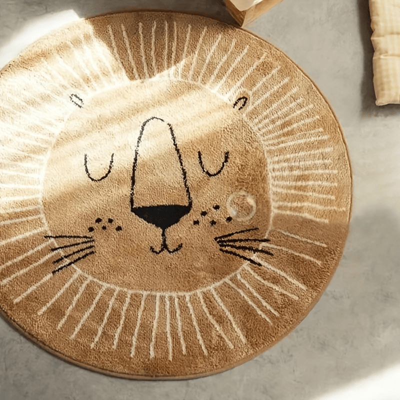 Round beige rug with a lion face design on a concrete floor.