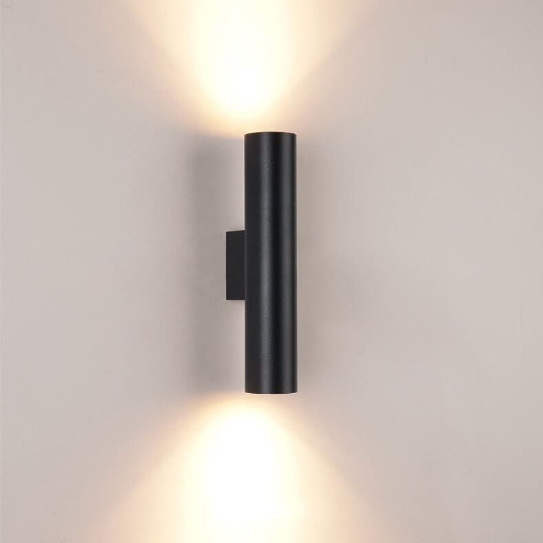 Black wall-mounted light fixture on a gray wall
