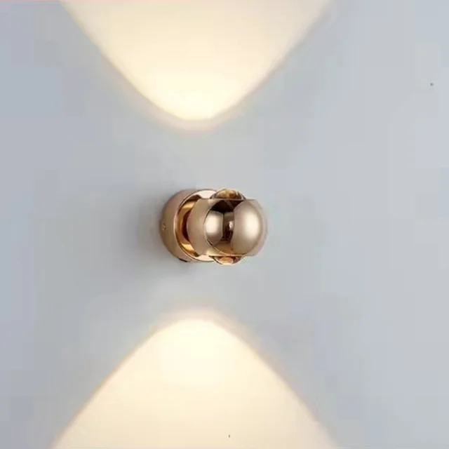 Gold wall sconce on a light gray wall