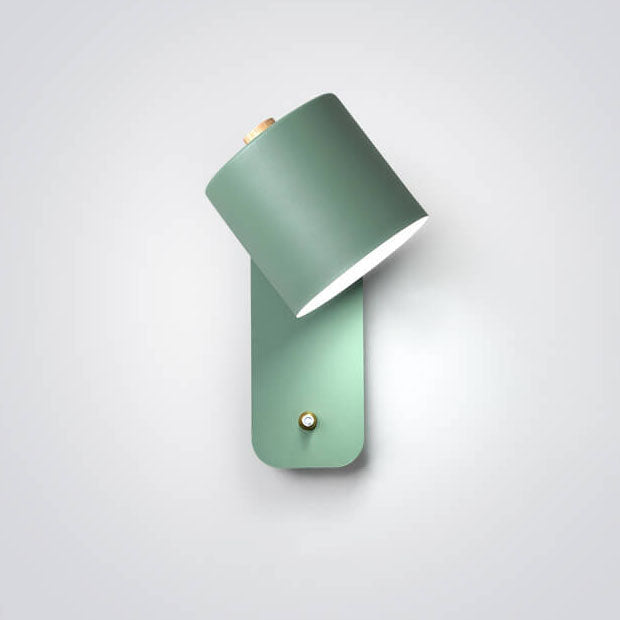 Green wall sconce with a white lampshade on a light gray background