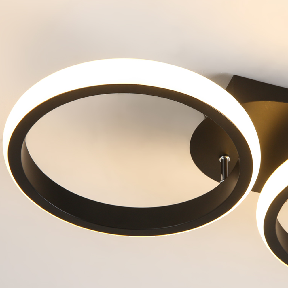 Modern ceiling light fixture with circular design on a neutral background