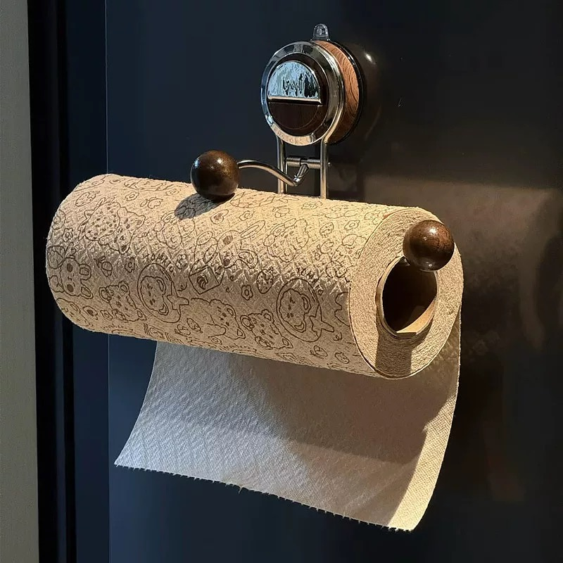 Roll of paper towel with decorative holder on a dark background