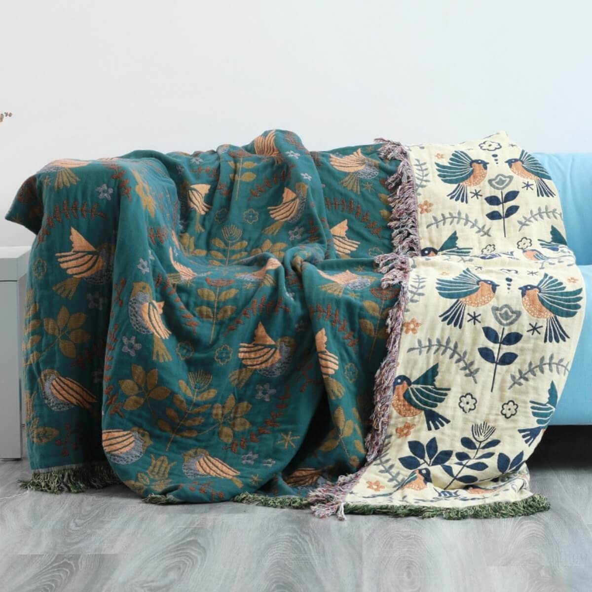 Two patterned blankets draped over a surface with a neutral background