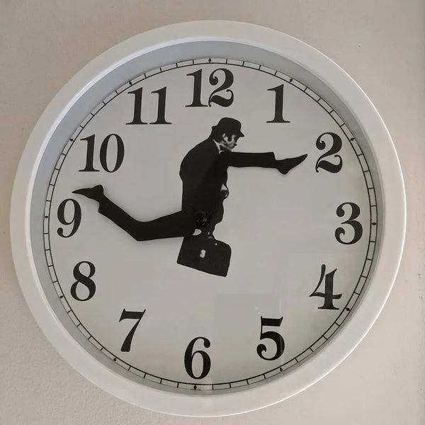 Wall clock with a design of a man running with a briefcase, indicating time passing.