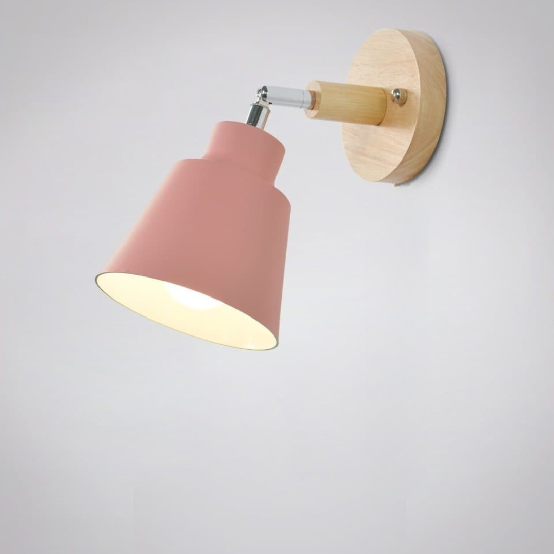 Wall-mounted light fixture with pink lampshade and wooden fixture on a light gray background
