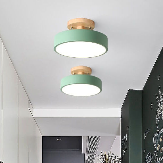 Two green ceiling lights with gold accents on a white ceiling.
