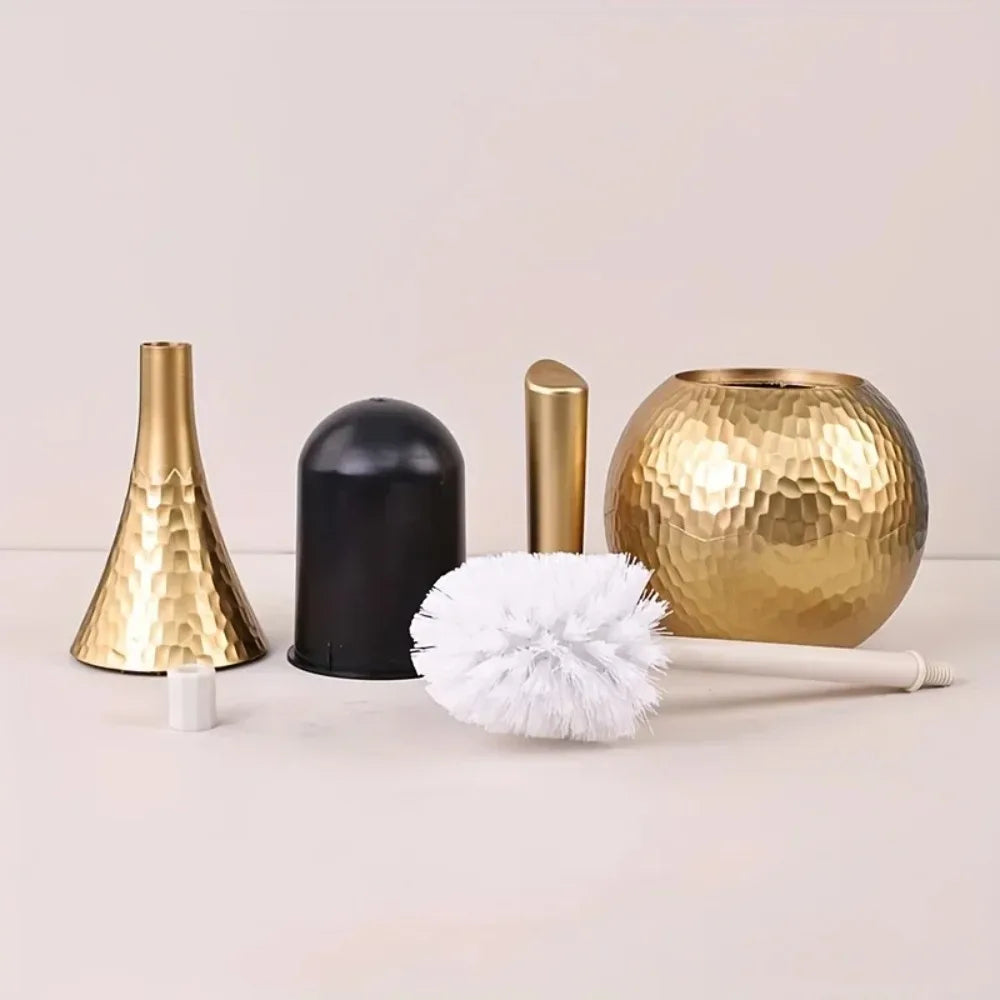 Set of gold and black bathroom accessories on a light background