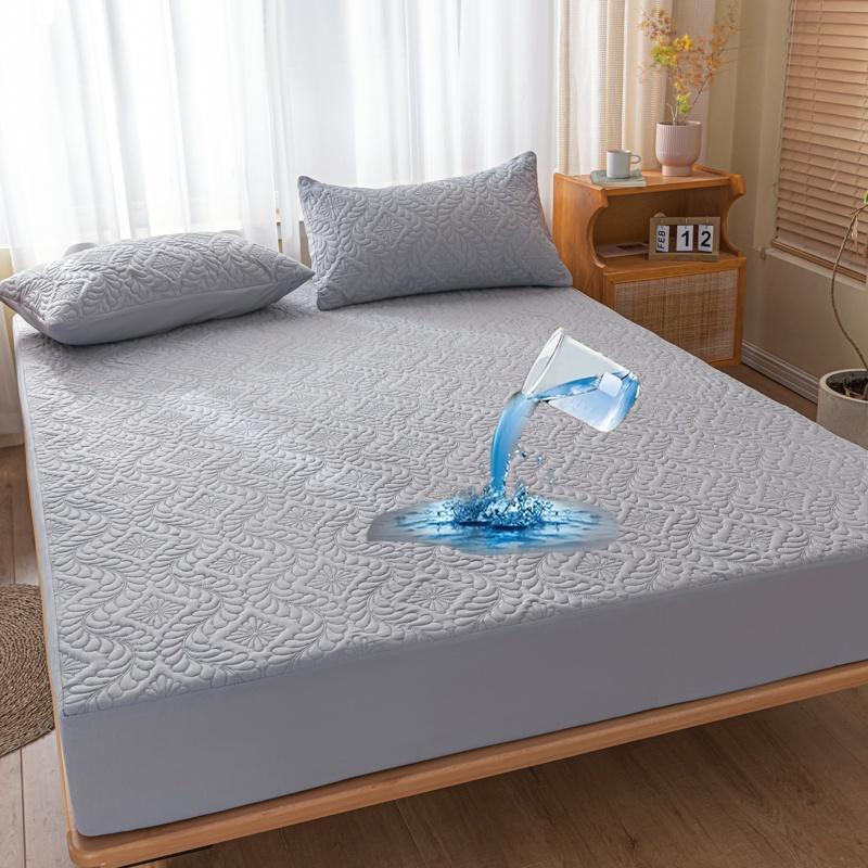 Gray mattress cover on a bed with water droplet effect in a bedroom setting