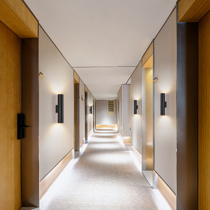 Modern hallway with wooden doors and wall lights