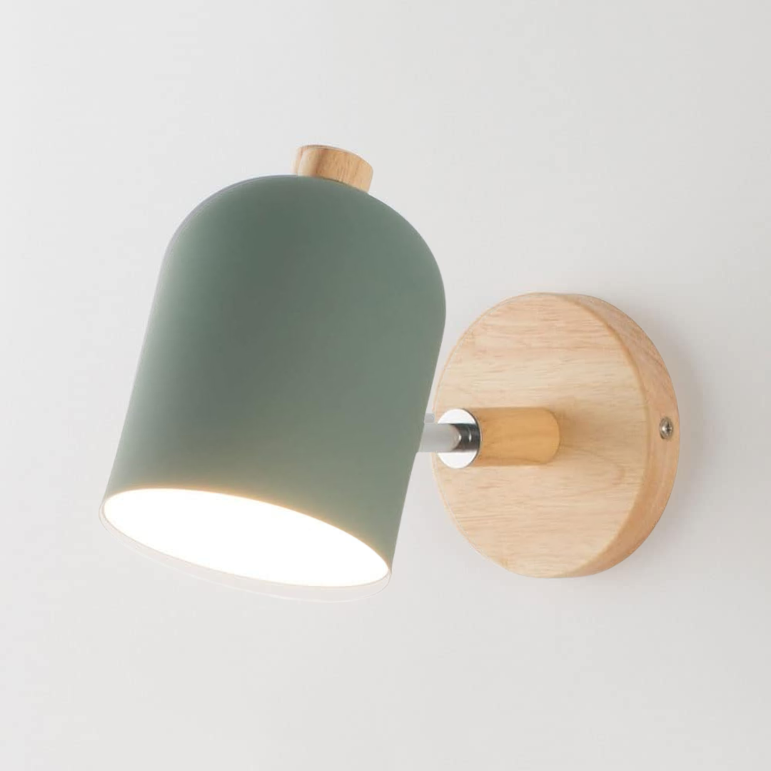 Wall-mounted light fixture with green shade and wooden base on a white background