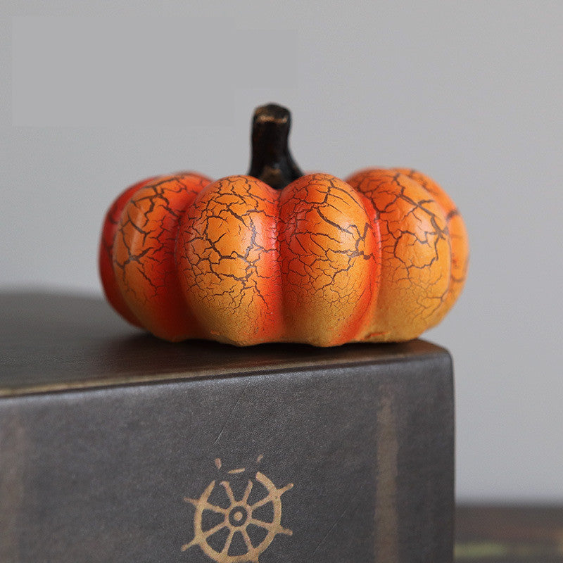 Decorative pumpkin with cracked texture on a gray surface
