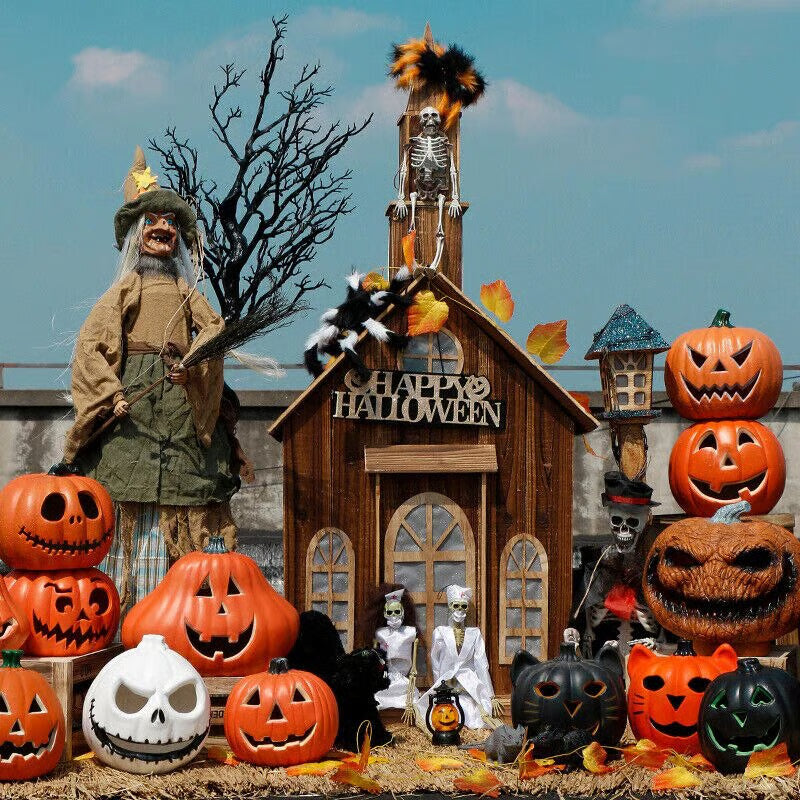 Halloween-themed display with pumpkins, a house, and skeletons against a blue sky.