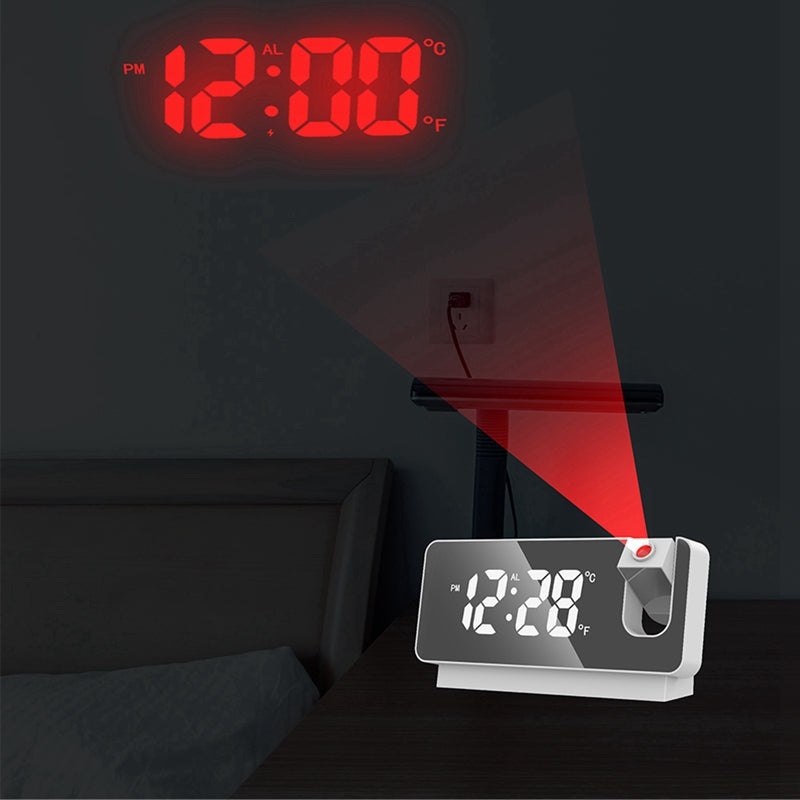 Digital clock projecting time onto a wall in a dark room.
