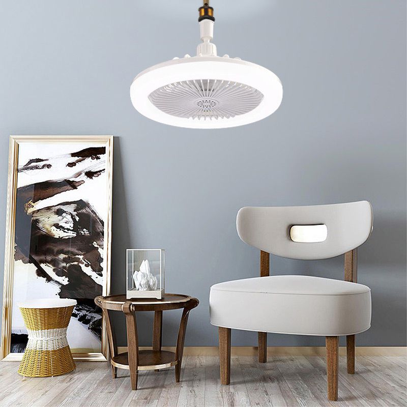 Modern interior design with a ceiling light fixture, chair, and side table against a gray wall.