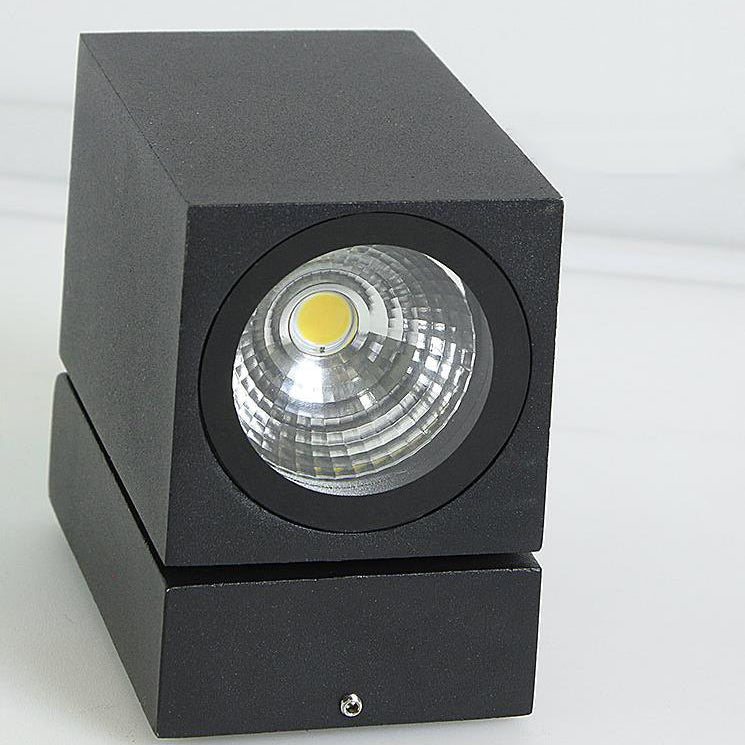 Black square spotlight with a visible LED bulb on a white background