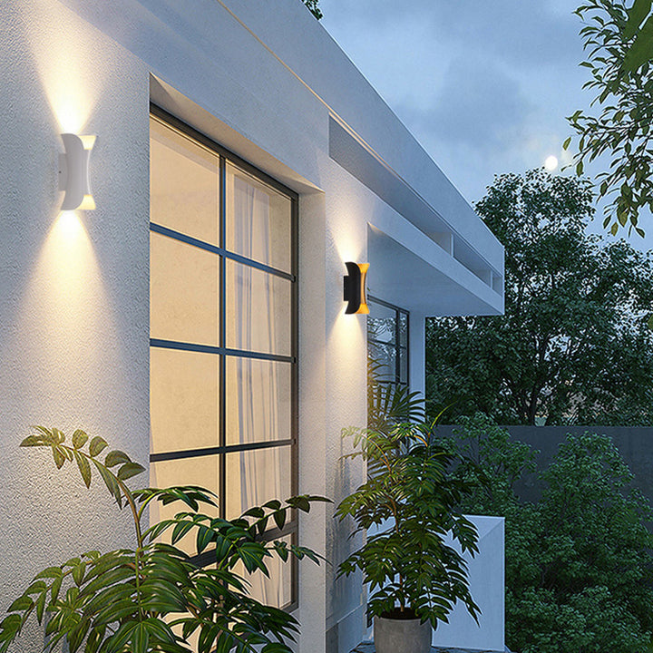 Modern building exterior with wall lights and plants