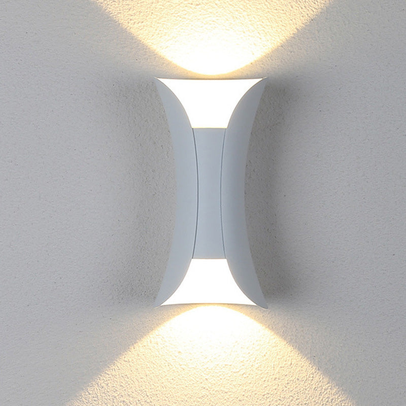 Modern wall-mounted light fixture on a textured white wall