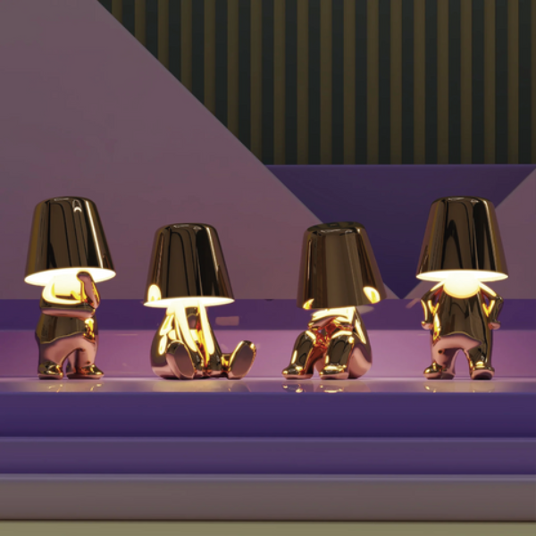 Four small metallic lamps on a reflective surface with a geometric background