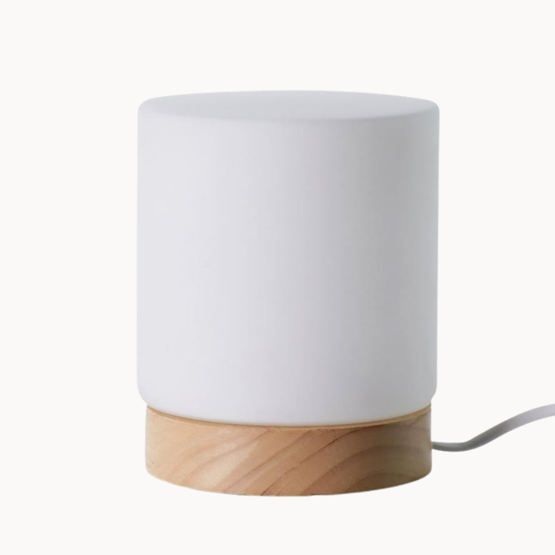 White ceramic lamp with wooden base on a white background