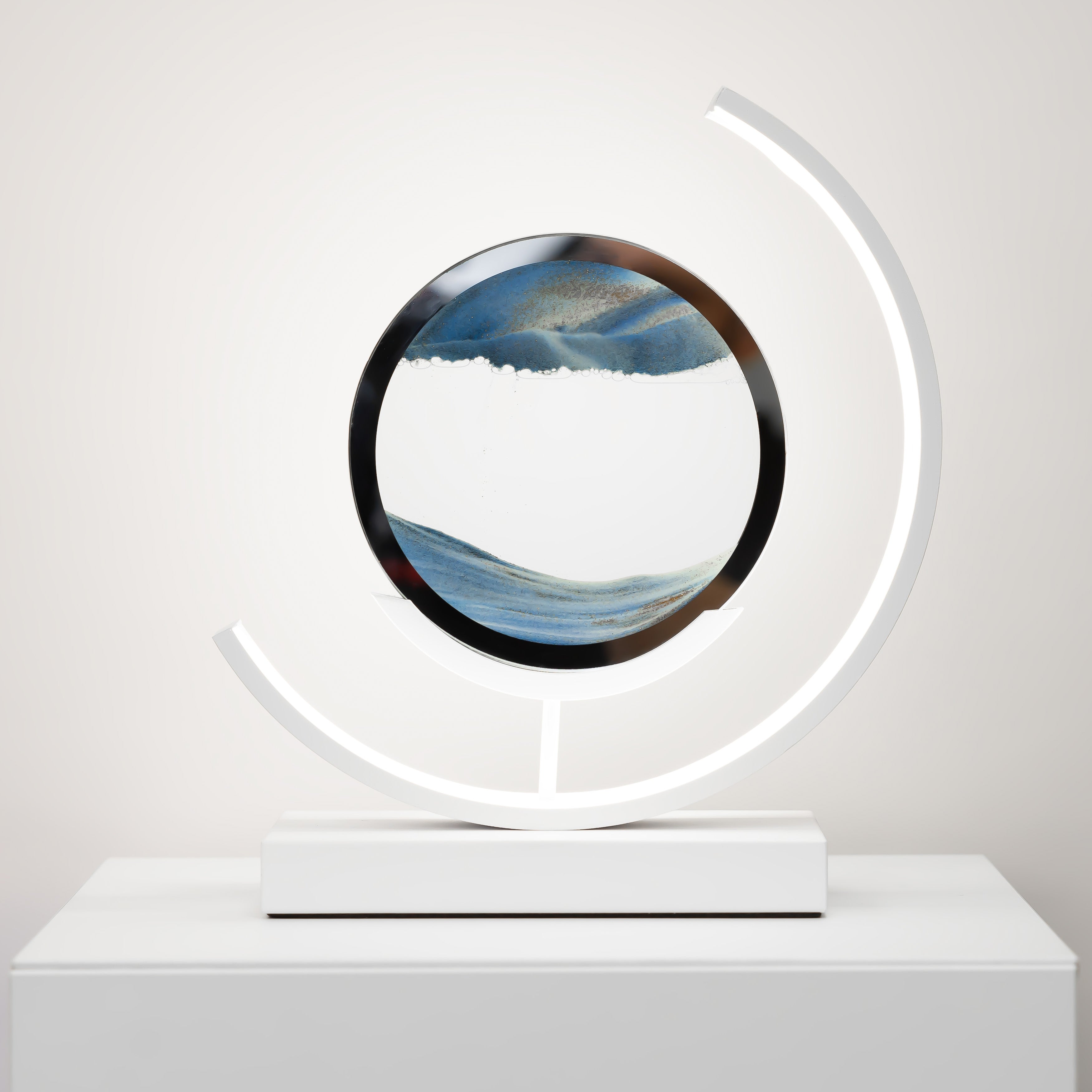 Decorative object with circular design and LED light on a white surface