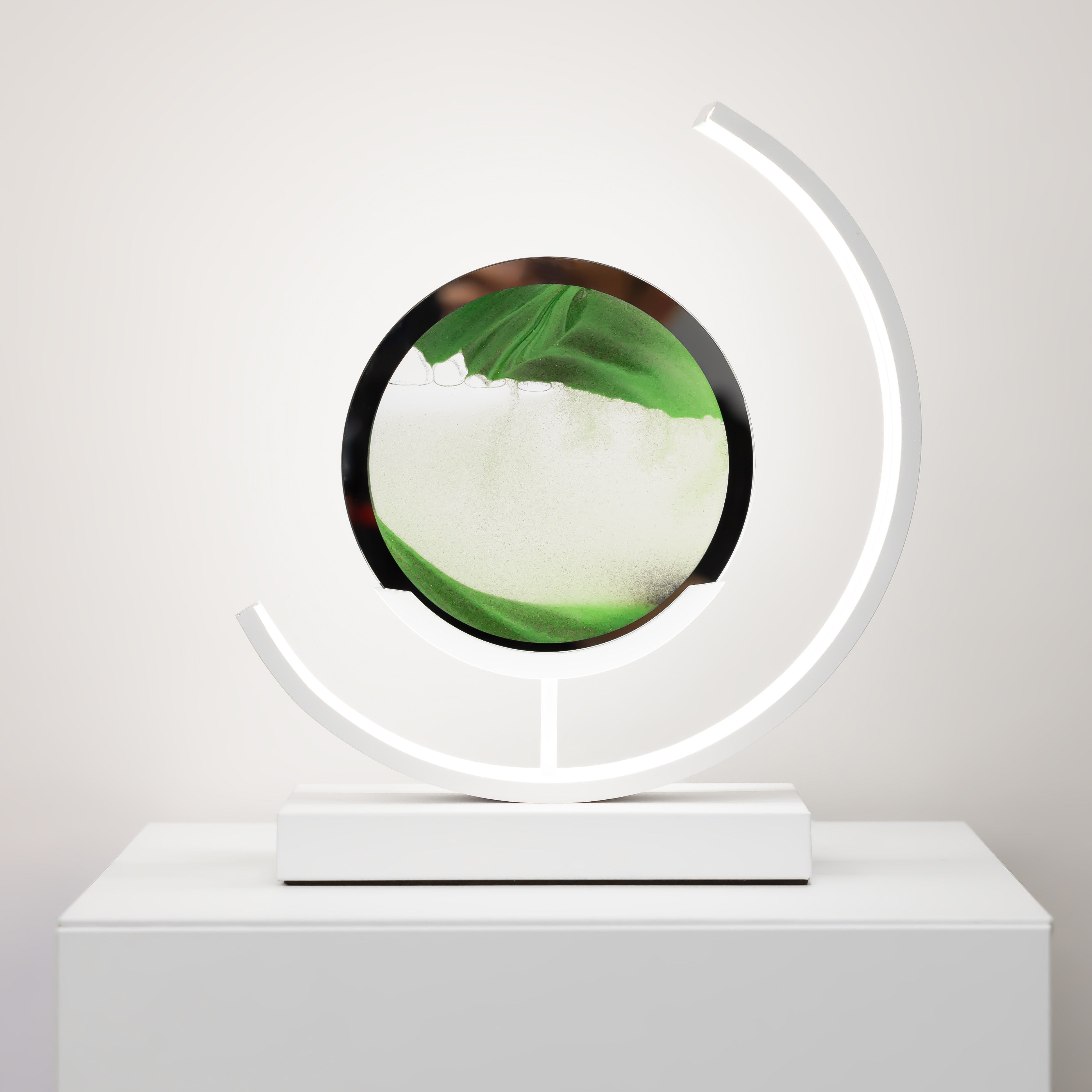 Decorative object with a circular design featuring a green leaf on a white background