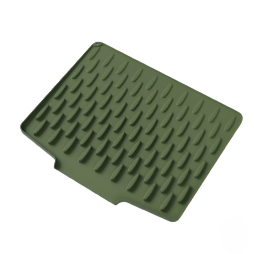 Green rubber mat with textured surface on a white background