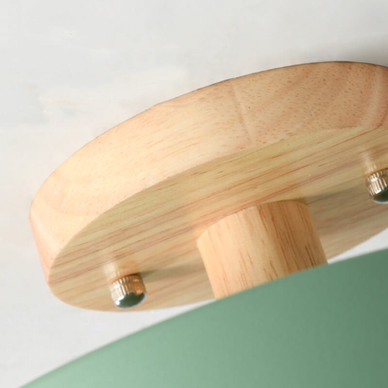 Close-up of a wooden lampshade with metallic fixtures on a white background