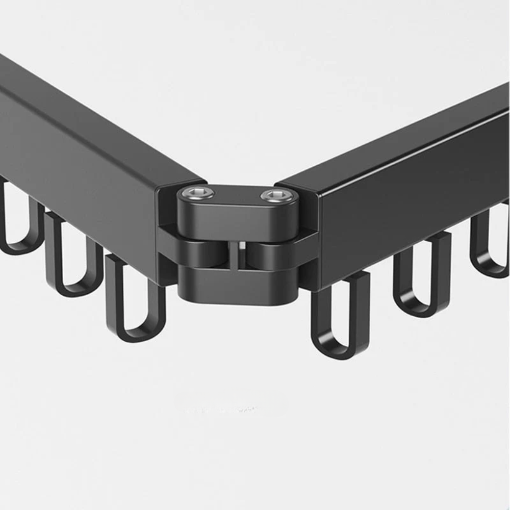 Close-up of a black metal bracket with hooks on a white background