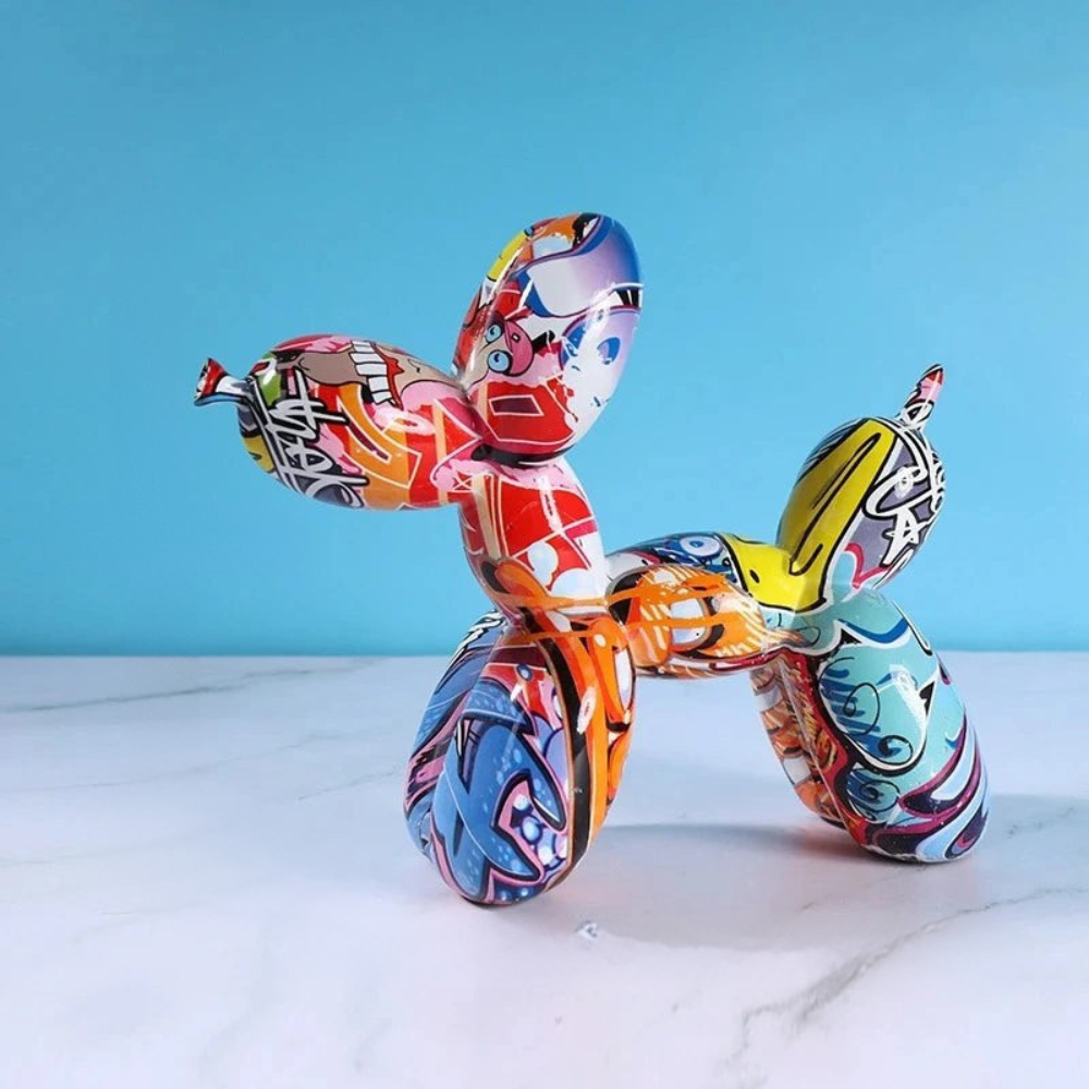 Colorful balloon animal sculpture on a marble surface with a blue background