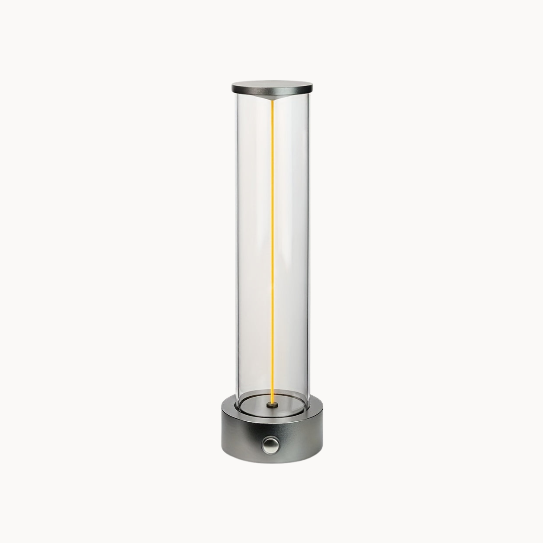 Cylindrical lamp with clear glass and metallic base on a white background