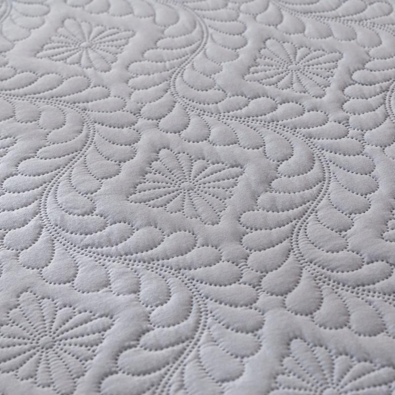 Close-up of textured gray fabric with floral patterns