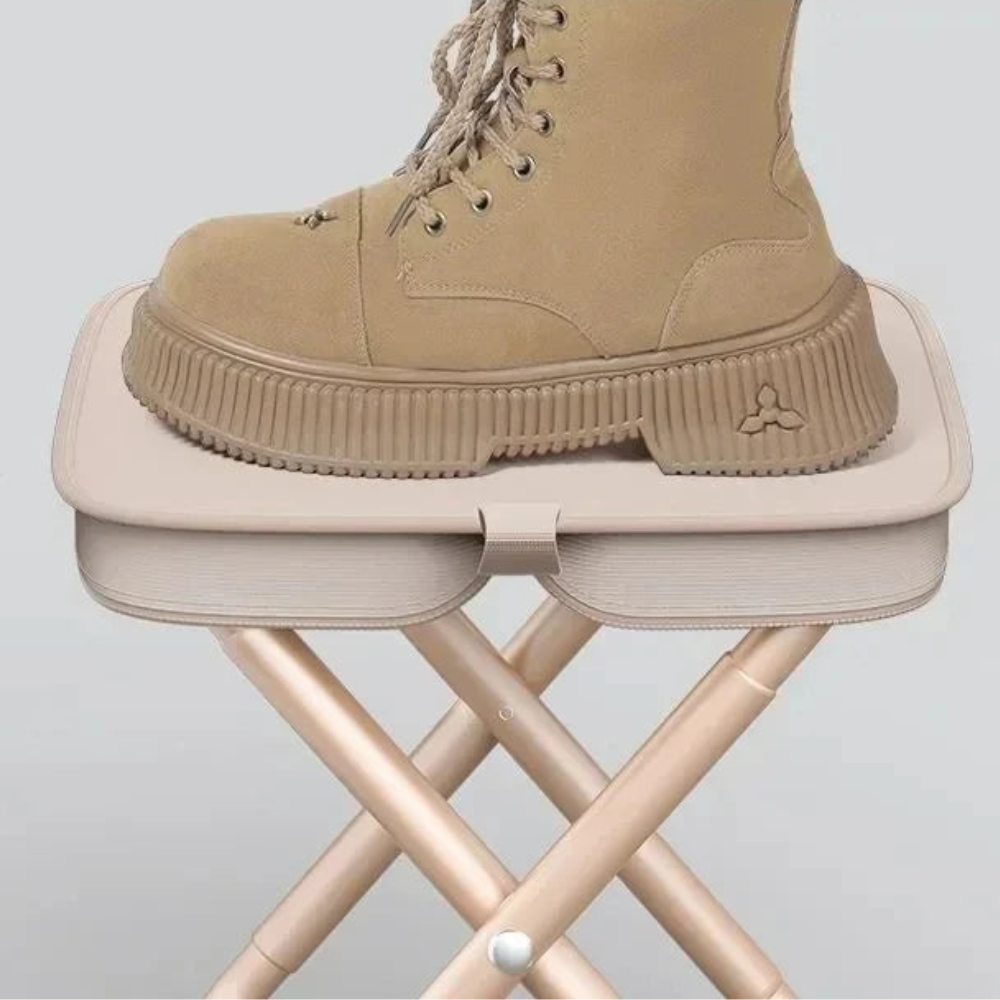 Tan boot on a small stool against a light gray background