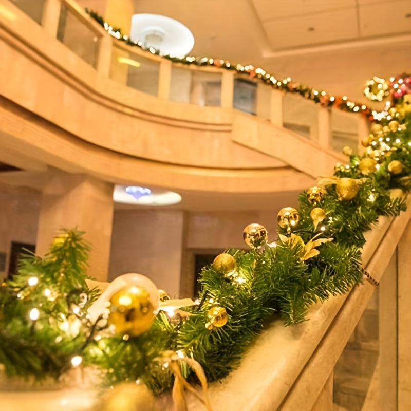 Decorative Christmas garland with gold ornaments on a staircase railing.