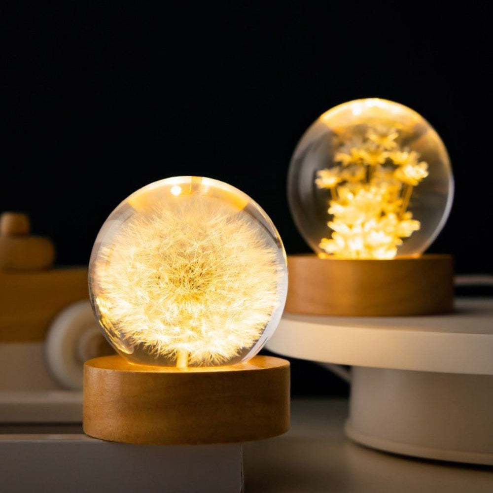 Two glowing spherical lights on wooden bases with a dark background