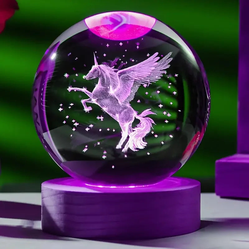 Crystal ball with a unicorn design on a purple stand against a green background