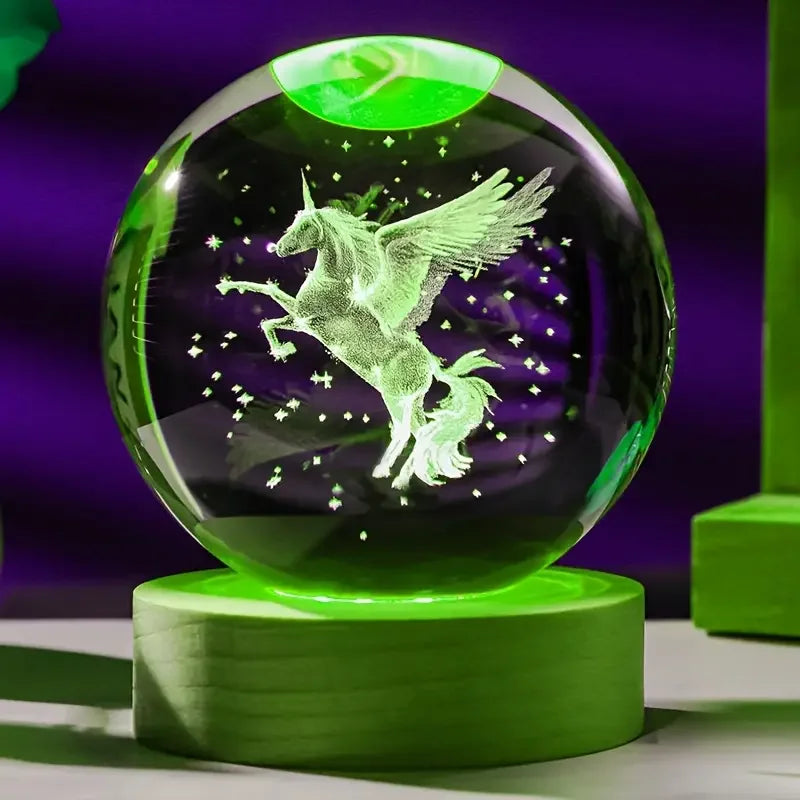 Crystal ball with a unicorn engraving on a green stand against a purple background