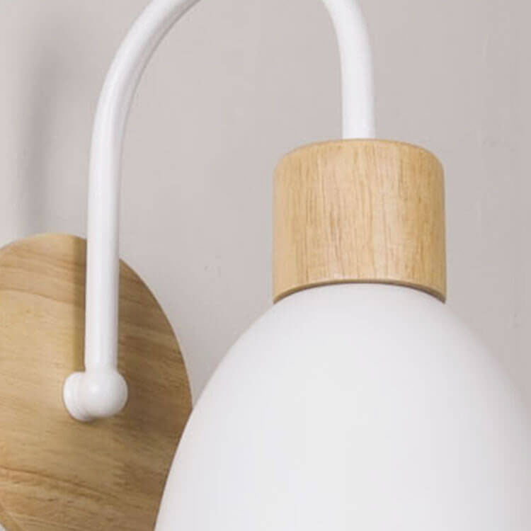 Close-up of a white pendant light with wooden accents on a neutral background
